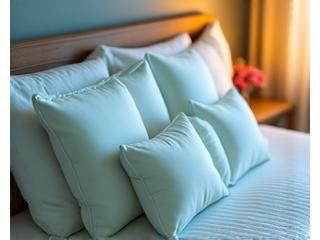 A comfortable bed with multiple orthopedic pillows and a supportive mattress, suggesting optimal sleep posture for joint relief.