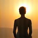 Person stretching at sunrise, representing improved lifestyle and energy.